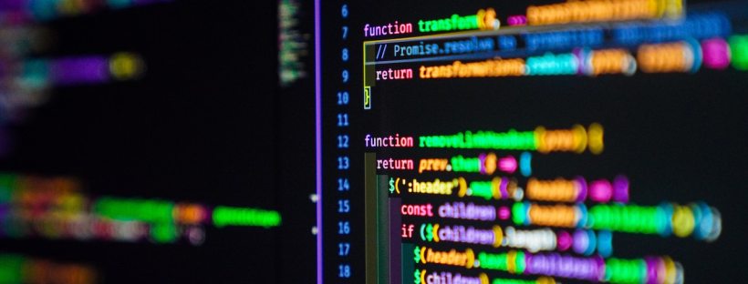 A bunch of computer code on a black screen. The type is rainbow coloured.