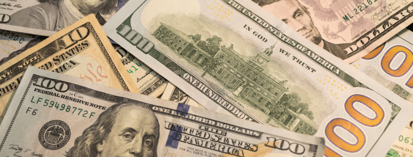 Various denominations of US money lays in the whole frame, scattered.