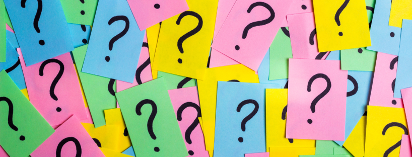 Multicoloured papers with big question marks on them